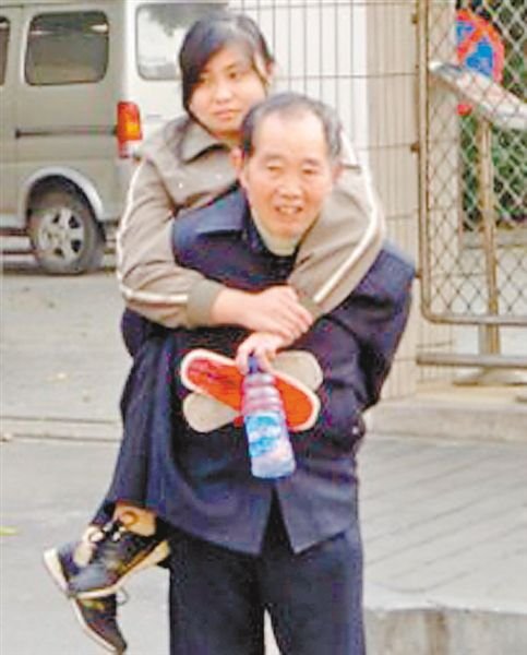 邱世祿背小娟上學(xué)。